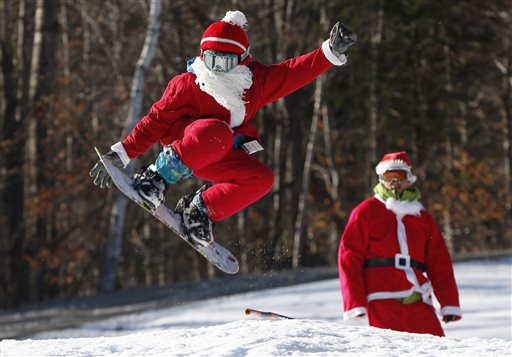 Snowboarder Jaden Bao, 12, of South Portland, Maine, catches some air while participating in Santa Sunday, the 16th annual charity fundraising event at the Sunday River ski resort, Sunday, Dec. 6, 2015, in Newry, Maine. (AP Photo/Robert F. Bukaty)