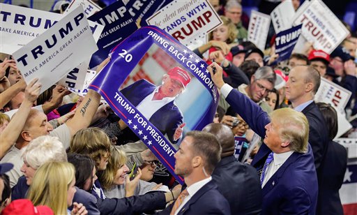 Republican presidential candidate Donald Trump signs autographs for supporters during a campaign stop at the Tsongas Center in Lowell, Mass., Monday, Jan. 4, 2016. (AP Photo/Charles Krupa)