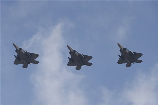 U.S. F-22 stealth fighters fly over Osan Air Base in Pyeongtaek, South Korea, Wednesday, Feb. 17, 2016. (AP Photo/Lee Jin-man)