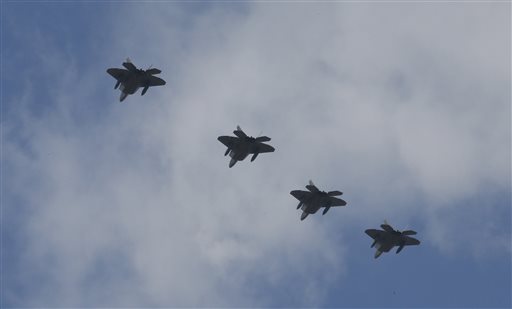 Four U.S. F-22 stealth fighters fly over Osan Air Base in Pyeongtaek, South Korea, Wednesday, Feb. 17, 2016. (AP Photo/Lee Jin-man)