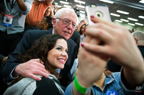 Democratic presidential candidate Sen. Bernie Sanders, I-Vt., poses for a selfie during a campaign rally on Sunday, Jan. 31, 2016, in Waterloo, Iowa. (AP Photo/Evan Vucci)