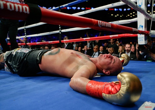 Artur Szpilka, of Poland, is knocked down during the ninth round of a WBC heavyweight title boxing match against Deontay Wilder, Saturday, Jan. 16, 2016, in New York. Wilder stopped Szpilka in the ninth round. (AP Photo/Frank Franklin II)