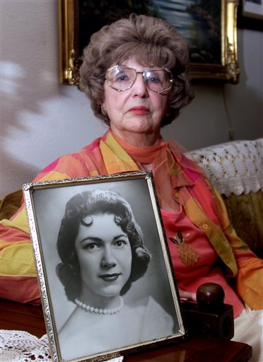 In this April 24, 2003, photo, Herlinda de la Vina holds a portrait of her niece, Irene Garza, the 25-year-old Texas schoolteacher and beauty queen in Edinburg, Texas, who was murdered in McAllen, Texas in 1960. The Maricopa County Sheriff's Department arrested 83-year-old John Feit, former priest, on Tuesday, Feb. 9, 2016, in the slaying of Garza. (Brad Doherty/The Dallas Morning News via AP) MANDATORY CREDIT; MAGS OUT; TV OUT; INTERNET USE BY AP MEMBERS ONLY; NO SALES