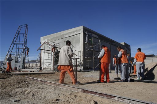 FILE - In this Jan. 17, 2016 file photo, inmates work on the construction of a chapel inside the state prison in Ciudad Juarez, Mexico. Pope Francis will conclude his weeklong Mexico trip with a visit to Ciudad Juarez where he will visit the prison and the chapel, on Wednesday, Feb. 17. (AP Photo/Dario Lopez-Mills)