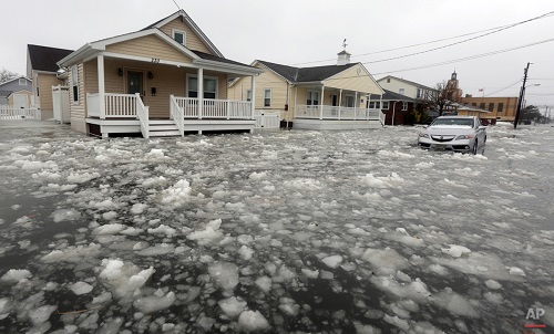 Water and ice floods 12th Ave in North Wildwood, N.J., at the height of the storm on Saturday, Jan. 23, 2016. A winter storm created near record high tides along the Jersey Shore, surpassing the tide of Hurricane Sandy according to North Wildwood city officials. (Dale Gerhard/Press of Atlantic City via AP)