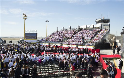 CORRECTS NAME OF AIRPORT - People wait for the arrival of Pope Francis at the Abraham Gonzalez International Airport in Ciudad Juarez, Mexico, Wednesday, Feb. 17, 2016. The pontiff is scheduled to wrap up his trip to Mexico on Wednesday with a visit in a Ciudad Juarez prison, just days after a riot in another lockup killed 49 inmates, and a stop at the Texas border when immigration is a hot issue for the U.S. presidential campaign. (AP Photo/Ivan Pierre Aguirre)