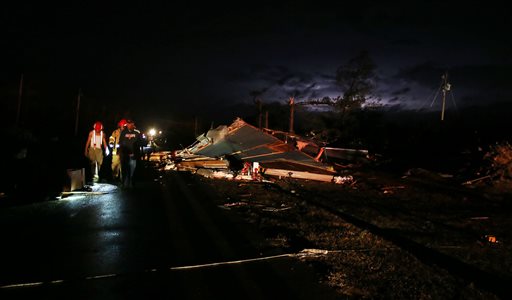 People look at debris after a storm passed through the Sapps mobile home park destroying many homes in Sapps, Ala., just outside of Aliceville on Tuesday, Feb. 2, 2016. Authorities say a large tornado in rural western Alabama left a trail of damage as powerful storms moved into the state. (Erin Nelson/The Tuscaloosa News via AP) MANDATORY CREDIT