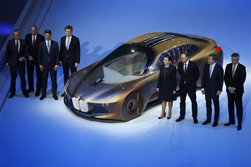 Harald Krueger, third from left, CEO of German carmaker BMW, and members of the board present the 'Vision Next 100' concept car during the 100th anniversary celebrations in Munich, Germany, Monday, March 7, 2016. (AP Photo/Matthias Schrader)