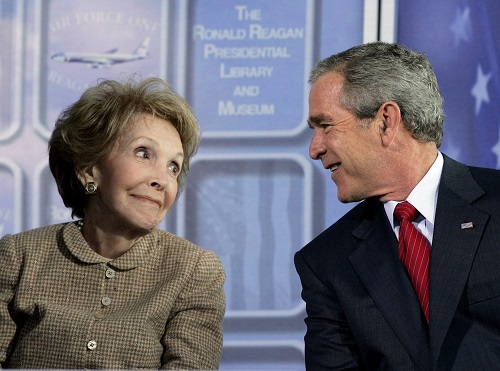 FILE - In this Oct. 21, 2005, file photo, President George W. Bush looks at former first lady Nancy Reagan during dedication ceremonies for the retired Air Force One Boeing 707 aircraft at the Ronald Reagan Presidential Library and Museum in Simi Valley, Calif. The former first lady has died at 94, The Associated Press confirmed Sunday, March 6, 2016. (AP Photo/Kevork Djansezian, File)