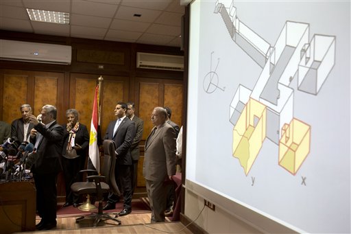 Egypt's Antiquities Minister Mamdouh el-Damaty, left, speaks during a press conference as he displays images of radar scans to King Tut's burial chamber on a projector, at the antiquities ministry in Cairo, Egypt, Thursday, March 17, 2016. El-Damaty says analysis of scans of famed King Tut's burial chamber has revealed two hidden rooms that could contain metal or organic material. (AP Photo/Amr Nabil)