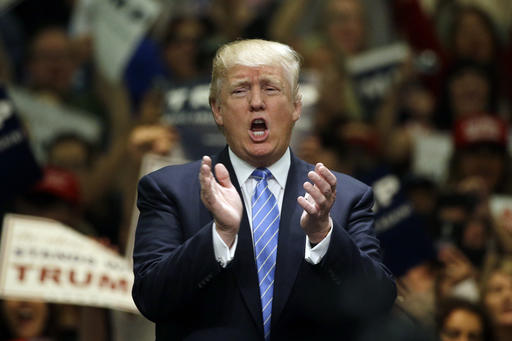 Republican presidential candidate Donald Trump applauds after singing the National Anthem during a rally at the Anaheim Convention Center, Wednesday, May 25, 2016, in Anaheim, Calif. (AP Photo/Jae C. Hong)