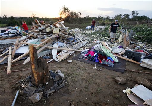 Friends and family of Lisa Buckner, not pictured, help to clean up after a tornado destroyed Buckner's home west of Wynnewood, Okla., in rural Gavin County, Monday, May 9, 2016. Storms swept through the nation's midsection Monday, spawning numerous tornadoes. (Nate Billings/The Oklahoman via AP) LOCAL STATIONS OUT (KFOR, KOCO, KWTV, KOKH, KAUT OUT); LOCAL WEBSITES OUT; LOCAL PRINT OUT (EDMOND SUN OUT, OKLAHOMA GAZETTE OUT) TABLOIDS OUT; MANDATORY CREDIT