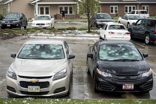Hail damaged cars sit in a parking lot Monday, May 9, 2016, in Lincoln, Neb. The National Weather Service says a tornado briefly touched down on the southeast edge of Lincoln, Neb., and there were reports of baseball-sized hail is falling in the area. (Kristin Stref/The Journal-Star via AP) LOCAL TELEVISION OUT; KOLN-TV OUT; KGIN-TV OUT; KLKN-TV OUT; MANDATORY CREDIT