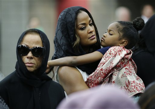 Muhammad Ali's wife Lonnie and her daughter Laila attend Muhammad Ali's Jenazah, a traditional Islamic Muslim service, in Freedom Hall, Thursday, June 9, 2016, in Louisville, Ky. Laila is holding her daughter Sydney Jurldine Conway. (AP Photo/David Goldman)