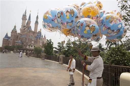 Workers prepare during the eve of the opening of the Disney Resort in Shanghai, China, Wednesday, June 15, 2016. Disney will open its first resort in mainland China on Thursday. (AP Photo/Ng Han Guan)
