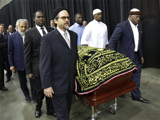 Muhammad Ali's casket is escorted by pallbearers for his Jenazah, a traditional Islamic Muslim service, in Freedom Hall, Thursday, June 9, 2016, in Louisville, Ky. (AP Photo/David Goldman)