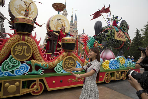 Characters from the Disney movie Mulan take part in a parade at the Disney Resort in Shanghai, China, Wednesday, June 15, 2016. The debut of Shanghai Disneyland offers Walt Disney Co. "incredible potential" for boosting its brand in the world's most populous market, Disney's chief executive said Wednesday ahead of Thursday's grand opening for the $5.5 billion park. (AP Photo/Ng Han Guan)