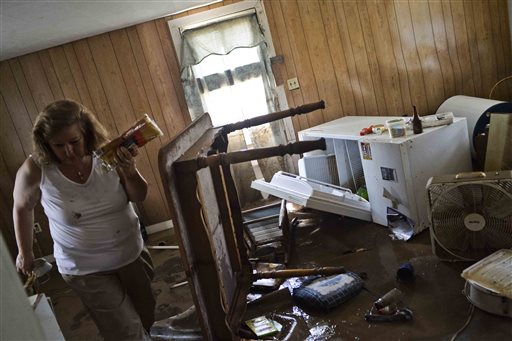 Theresa Havers helps clean out the kitchen of her son's home after flooding in Rainelle, W.Va., Sunday, June 26, 2016. (Christian Tyler Randolph/Charleston Gazette-Mail via AP) MANDATORY CREDIT