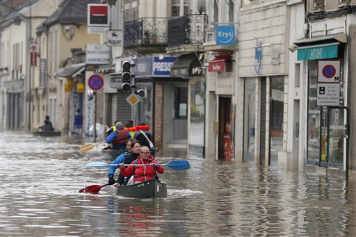 Residents evacuate their home in Nemours, 50 miles south of Paris, Thursday, June 2, 2016. Floods inundating parts of France and Germany have left five people reported dead and thousands trapped in homes or cars, as rivers have broken their banks from Paris to Bavaria. (AP Photo/Francois Mori)