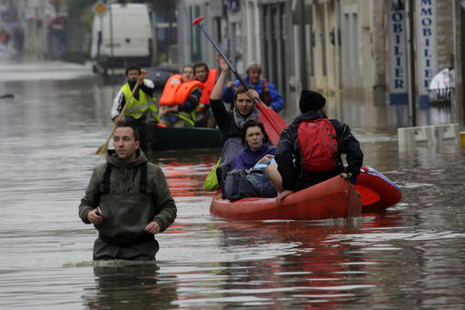 Residents evacuate their home in Nemours, south of Paris, Thursday, June 2, 2016. Floods inundating parts of France and Germany have left five people dead and thousands trapped in homes or cars, as rivers have broken their banks from Paris to Bavaria.(AP Photo/Jerome Delay)