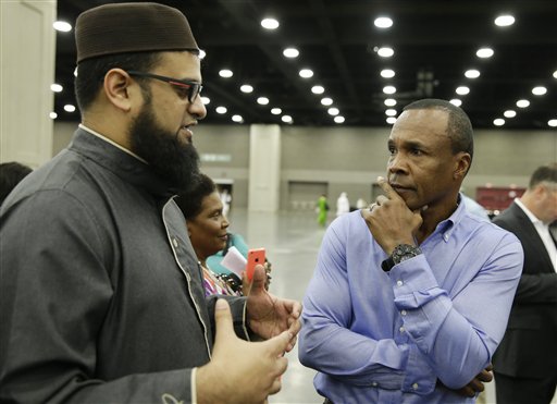 Safih Amed, left speaks with former boxing champion Sugar Ray Leonard before Muhammad Ali's Jenazah, a traditional Islamic Muslim service, in Freedom Hall, Thursday, June 9, 2016, in Louisville, Ky. (AP Photo/Darron Cummings)