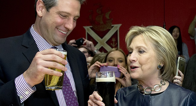 Democratic presidential candidate Hillary Clinton, right, has a Guinness and and Rep. Tim Ryan, D-Ohio, left, has a beer in the packed O'Donold's Irish Pub and Grill in Youngstown, Ohio, Saturday, March 12, 2016. (AP Photo/Carolyn Kaster)