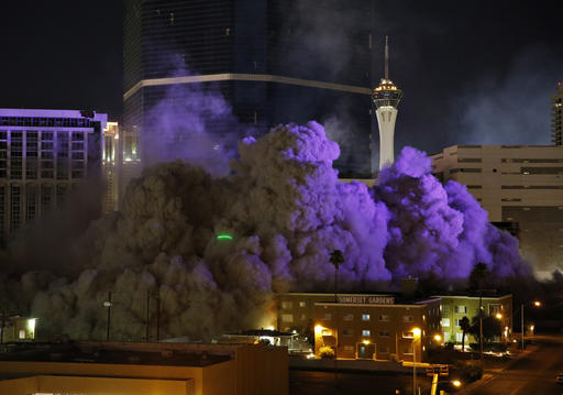 The Monaco Tower at the Riviera Hotel and Casino crumbles to the ground during a controlled demolition, Tuesday, June 14, 2016, in Las Vegas. The casino opened in 1955 and was closed last year to make room to expand the Las Vegas Convention Center. (AP Photo/John Locher)