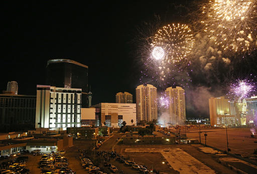 Fireworks explode by the Monaco Tower at the Riviera Hotel and Casino before a controlled demolition of the tower, Tuesday, June 14, 2016, in Las Vegas. The casino opened in 1955 and was closed last year to make room to expand the Las Vegas Convention Center. (AP Photo/John Locher)