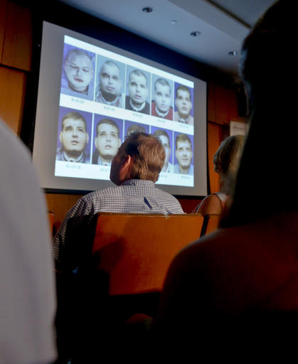 Former Mississippi firefighter Patrick Hardison, 42, center, views a video showing progression of his face transplant, during a press conference marking one year after his surgery, Wednesday Aug. 24, 2016, at New York University Langone Medical Center in New York. Hardison was disfigured while trying to save people from a house fire in 2001 and received the face of a Brooklyn cyclist who died in an accident in July 2015-- a surgery successfully perform by a team of doctors at NYU Langone. (AP Photo/Bebeto Matthews)