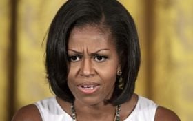 First lady Michelle Obama hosts the Smithsonian's Cooper-Hewitt National Design Award luncheon in the East Room of the White House in Washington, Friday, July 13, 2012. A District of Columbia police officer who worked as a motorcycle escort for the White House and other officials has been moved to administrative duty after he allegedly made threatening comments about Michelle Obama.  (AP Photo/J. Scott Applewhite)