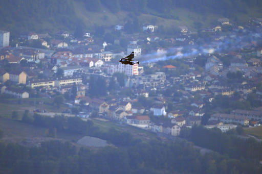 Swiss pilot Yves Rossy, known as 'Jetman,' the first man in the world to fly a jet-fitted wing, performs a flight during the 43st Icare Cup paragliding festival in Saint Hilaire du Touvet, French Alps, Saturday, Sept. 24, 2016. The "Coupe Icare" dedicated to free flight, orchestrates all the various types of flying such as hang gliding, paragliding and acrobatic sailplaneing. (AP Photo/Francois Mori)