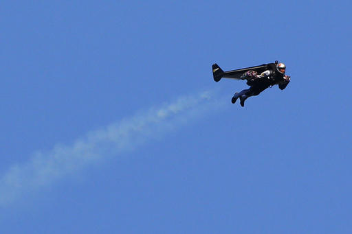 Swiss pilot Yves Rossy, known as 'Jetman,' the first man in the world to fly a jet-fitted wing, performs a flight during the 43st Icare Cup paragliding festival in Saint Hilaire du Touvet, French Alps, Saturday, Sept. 24, 2016. The "Coupe Icare" dedicated to free flight, orchestrates all the various types of flying such as hang gliding, paragliding and acrobatic sailplaneing. (AP Photo/Francois Mori)
