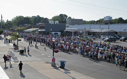 FILE - In this June 11, 2016 file photo, volunteers and participants take their spots during the world record attempt for the longest ice cream dessert along eight city blocks in Ludington, Mich. House of Flavors, one of Michigan's original, continuously-operating ice cream makers and parlors put on the event. Guinness World Records informed Ludington this week that the ice cream shop now holds the record after the June event. Officials say the sundae measured a bit over 2,970 feet in length. According to Guinness, the previous record for the longest ice-cream dessert of 1,957 feet and 1 inch was set in 2015 in Manurewa, New Zealand. (Joel Bissell/Muskegon Chronicle-MLive.com via AP, File)