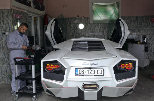 Kosovo car enthusiast Driton Selmani works on his hand made replica of a Lamborghini in his workshop in the town of Gjilan on Thursday, Oct. 27, 2016. Selmani always wanted some hot wheels but could not afford them. What he had, however, was a workshop and talent for bending and welding metal. so he built himself a Lamborghini. (AP Photo/Visar Kryeziu)