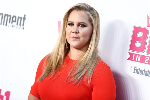 FILE - In this Nov. 15, 2015 file photo, Amy Schumer attends the VH1 Big In 2015 with Entertainment Weekly Award Show in West Hollywood, Calif. Gallery Books, an imprint of Simon & Schuster, announced Tuesday, March 8, 2016, that Schumer's upcoming book, called, "The Girl With the Lower Back Tattoo," is scheduled to come out on Aug. 16. (Photo by John Salangsang/Invision/AP, File)