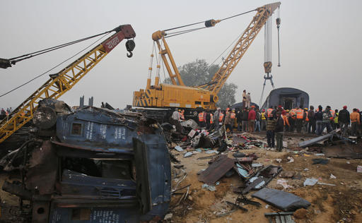 Rescuers work at the site after 14 coaches of an overnight passenger train rolled off the track near Pukhrayan village in Kanpur Dehat district of the northern Indian state of Uttar Pradesh, India, Monday, Nov. 21, 2016. Scores of passengers died and scores more were injured in the accident. (AP Photo/Rajesh Kumar Singh)